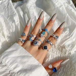 Detailed close-up of elegant S925 silver rings with blue teardrop and heart-shaped zircon