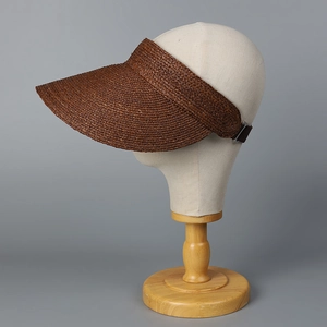 Detail of high-density raffia sun visor with adjustable strap and textured weave