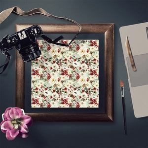 Flat lay of vintage Christmas scrapbook paper with floral patterns and wooden frame