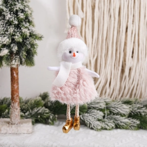 Pink plush snowman Christmas ornament with knit hat and golden boots hanging on a tree