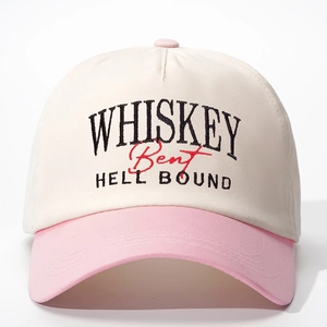 Detailed close-up of Whiskey embroidery on a beige and pink two-tone baseball cap
