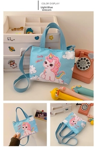 Close-up of light blue unicorn crossbody bag with Lucky unicorn print and strap