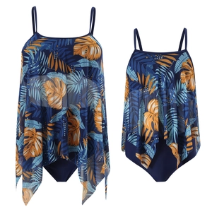 Detail of two-layer tankini with tropical leaf mesh overlay and adjustable straps