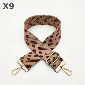 Detail of thickened chevron weave handbag strap with adjustable light gold metal buckles