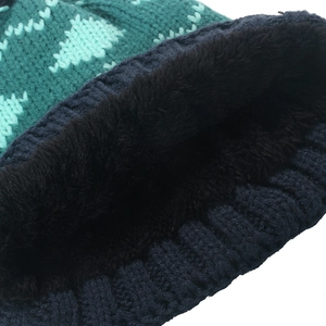 Close-up of winter knit hat showing thick thermal fleece lining and diamond pattern