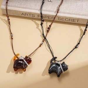 Artistic cat sweater necklace with resin tiger eye and pearl butterfly bow accents