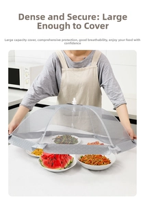 Detailed view of large foldable grey mesh food cover protecting multiple dishes on table