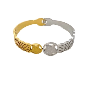 Two-tone gold and silver star bangle bracelet with hollow pattern and buckle clasp