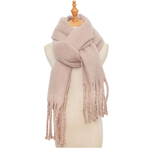 Close-up of beige mohair knit scarf with tassel fringe on a wooden mannequin stand