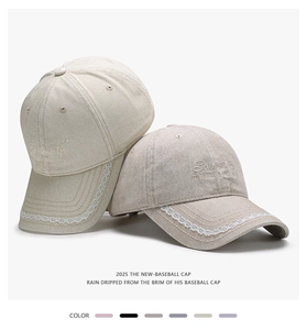 Close-up of baseball caps featuring elegant lace trim and artistic embroidery details