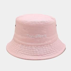 Detail of pink cotton bucket hat featuring white Traveller's embroidery and metal eyelets