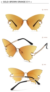 Detail of gold-brown orange butterfly sunglasses with textured metal temples and frameless lenses