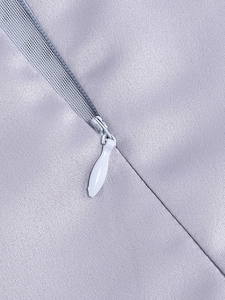 Detailed close-up of the hidden zipper and stitching on the purple ruched dress