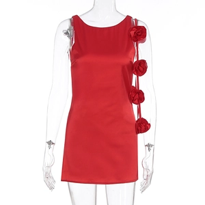 Close-up of 3D handmade roses and satin fabric on a red backless cocktail dress