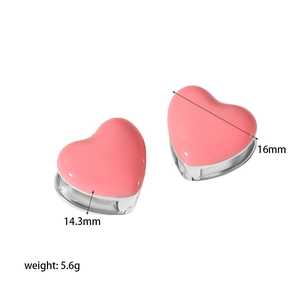 Detailed view of pink heart earrings with dimensions 14.3mm by 16mm and 5.6g weight