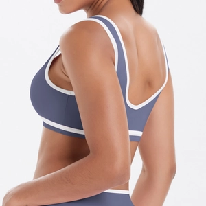 Détail d'une brassière de yoga dos nu avec liserés contrastés et tissu sport mat