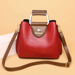 Red PU leather tote bag with brown handles and a stylish detachable woven shoulder strap