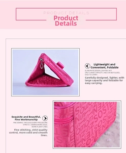 Detail of pink satin makeup bag showing foldable design, sturdy handle and fine stitching
