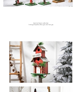 Detail of red tiered wooden birdhouse with Merry Christmas sign and snow accents