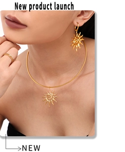 Detailed view of bohemian sunburst necklace and earrings set in 18k gold plated steel