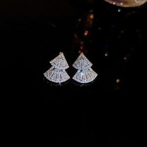 Macro shot of silver zircon stud earrings with double layered fan-shaped design
