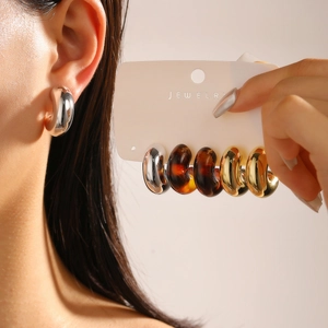 Three-pair set of chunky hoop earrings in gold, silver, and leopard resin finish