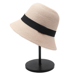 Japanese style beige straw bucket hat with black ribbon bow for summer sun protection