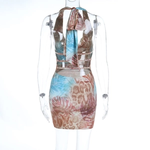 Back view detail of halter mini dress featuring tropical palm leaf and leopard print