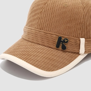 Brown corduroy baseball cap for toddlers featuring metal letter K and ivory brim piping