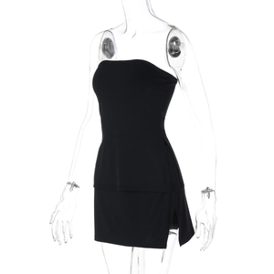 Detail showing side slit on a sexy black strapless tube top and bodycon mini skirt set