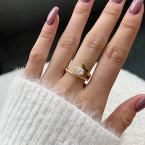 Close-up of a gold ring with oval 8A zircon and pavé diamonds worn on a finger