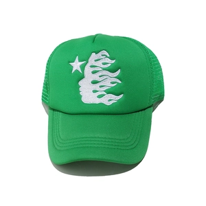 Close-up of Hellstar style white embroidery and breathable mesh on a green trucker hat