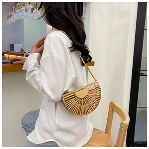 Detail of a handmade semi-circular bamboo woven bag with wooden bead shoulder strap