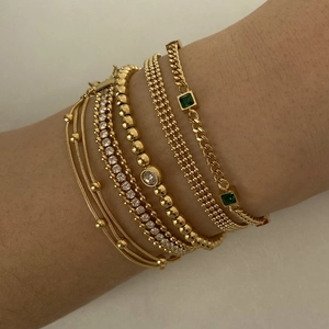 Stackable PVD gold plated stainless steel bracelets with emerald green stones and tennis chain
