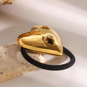 Polished 18K gold hollow heart pendant on black elastic hair tie for luxury styling