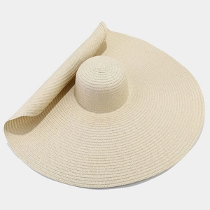 Detailed weave pattern and curved edge of a wide brim straw sun hat for women