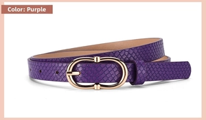 Macro detail of purple snakeskin embossed leather belt with gold oval metal buckle