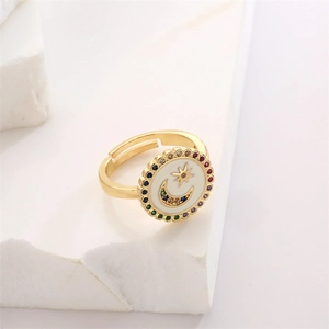 Macro view of gold star moon ring with colorful gems on a minimalist stone base