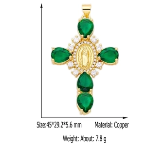 Detailed size view of gold copper cross pendant with green gemstone and religious relief