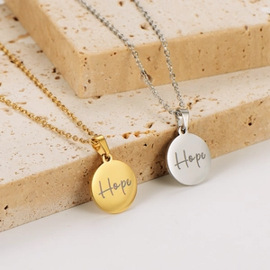 18k gold and silver stainless steel Hope circle pendant necklaces on stone background