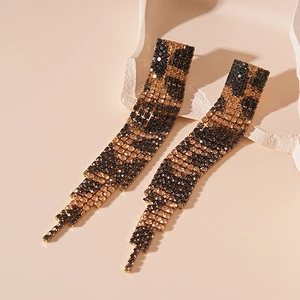 Detailed view of leopard print rhinestone tassel earrings with a champagne gold finish
