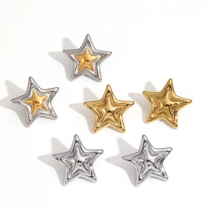 Three pairs of 18k gold and silver stainless steel star stud earrings on white backdrop