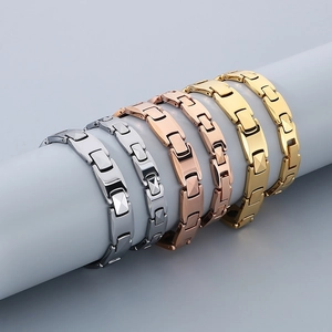 Polished tungsten steel bracelets in silver, gold, and rose gold on a grey display stand