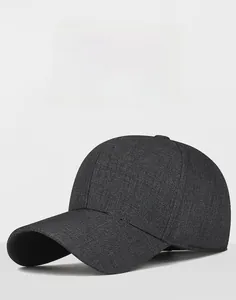 Detail view of a dark grey business baseball cap featuring a silver metallic M emblem