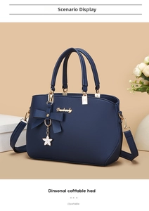Detail of dark blue litchi grain tote bag with bow decoration and star metal pendant