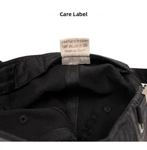 Detail view of cotton care label and internal stitching on this black baseball cap