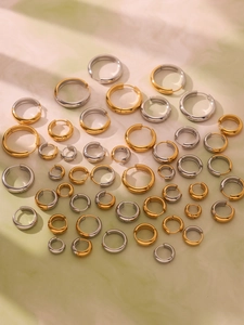 Macro shot of assorted gold and silver stainless steel hoop earrings in various sizes