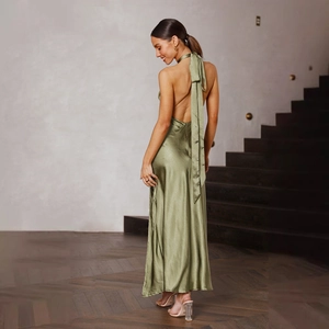 Detail of a satin halter maxi dress featuring a low back and flowing olive green fabric