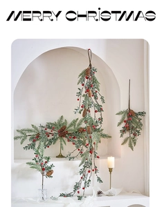 Detailed view of Christmas garland with pine branches, red berries and pine cones