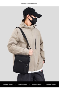 Close-up of a black waterproof crossbody bag featuring a metal logo and front zipper pocket